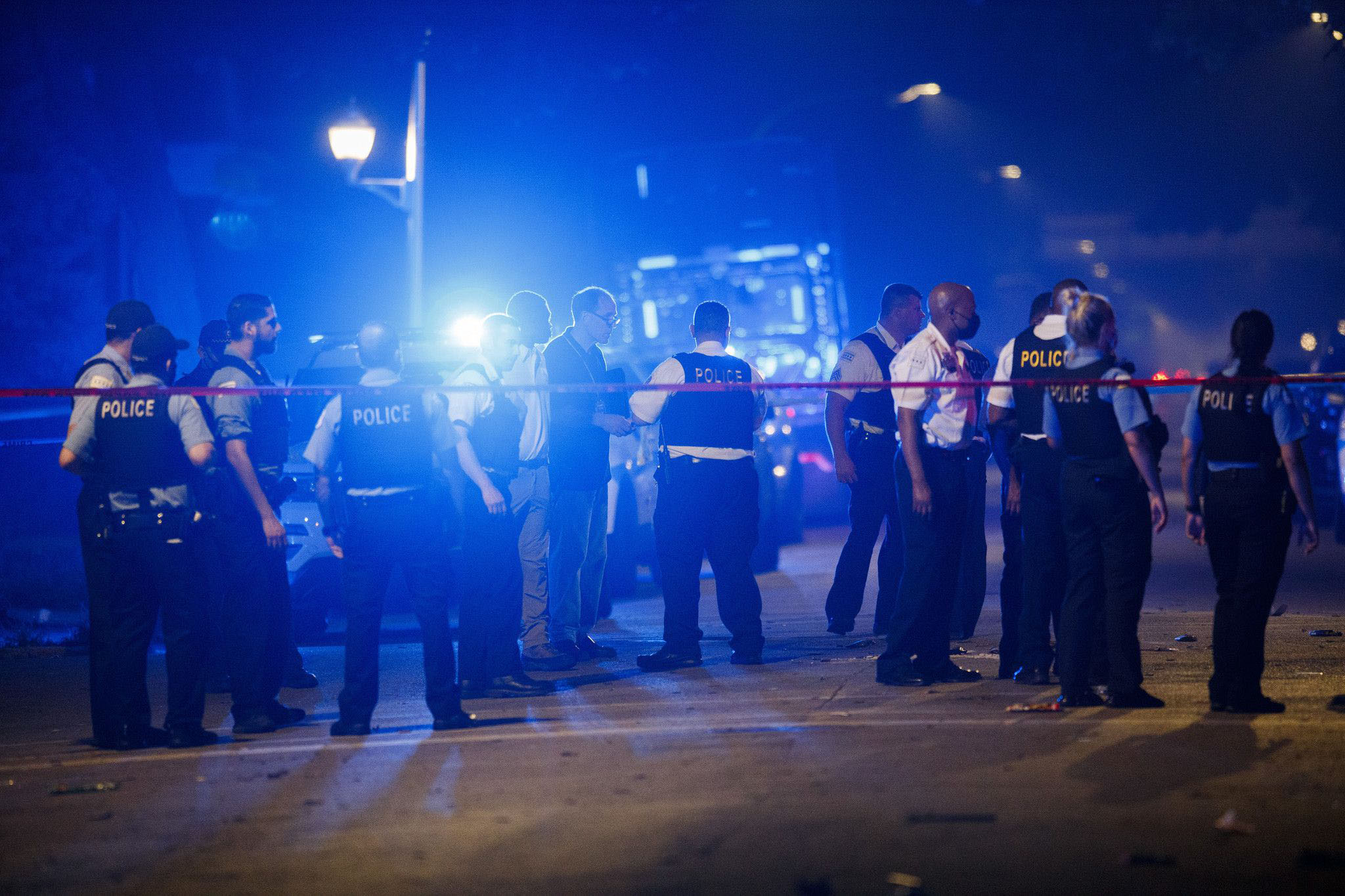 PHOTO: Police work the scene where eight people were shot, four fatally, including a 14-year-old boy, on the 6100 block of South Carpenter Street on July 5, 2020, in Chicago.