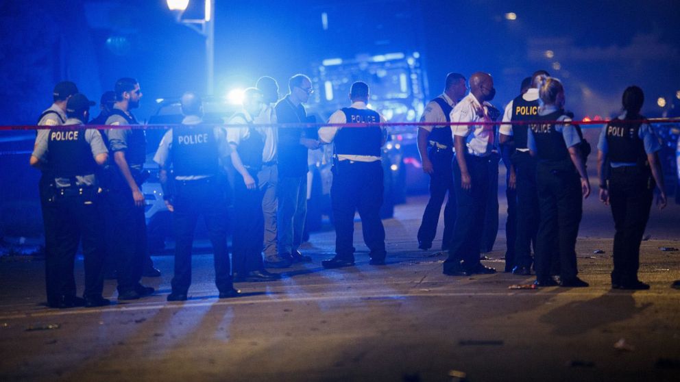 PHOTO: Police work the scene where eight people were shot, four fatally, including a 14-year-old boy, on the 6100 block of South Carpenter Street on July 5, 2020, in Chicago.