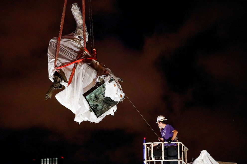 PHOTO: Crew members remove the Christopher Columbus statue from the Grant Park in Chicago, July 24, 2020.