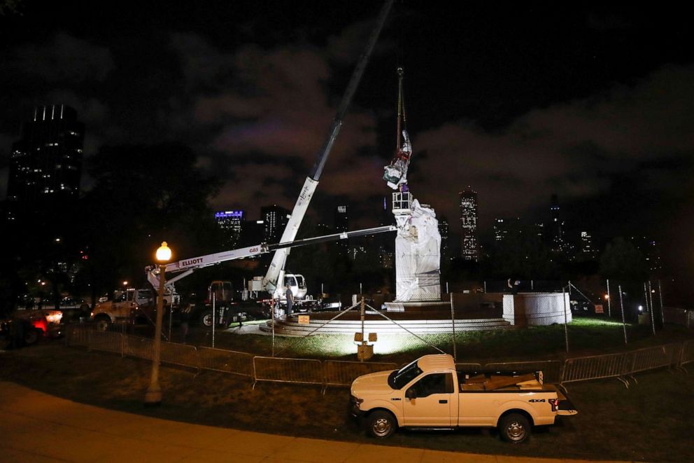 PHOTO: Crew members remove the Christopher Columbus statue from the Grant Park in Chicago, July 24, 2020.