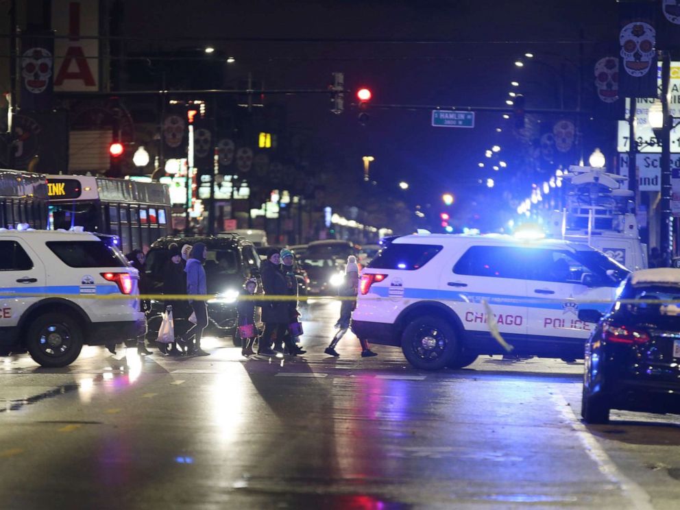 PHOTO: Trick-or-treaters walk past a crime scene in Chicagos Little Village neighborhood, where a 7-year-old girl was shot on Oct. 31, 2019.