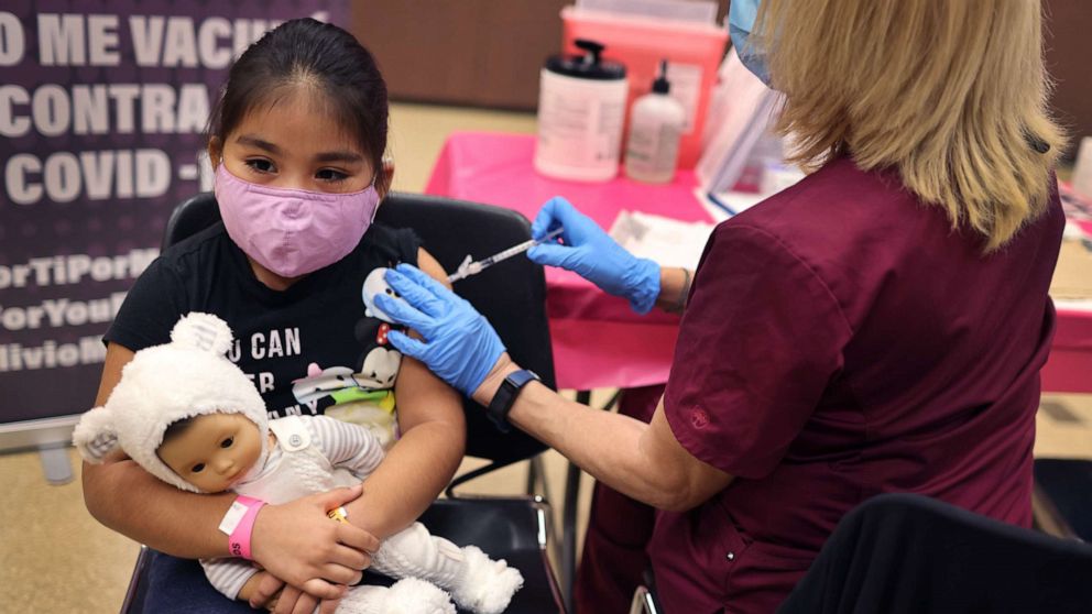 PHOTO: First grade student, seven-year-old Rihanna Chihuaque, receives a covid-19 vaccine at Arturo Velasquez Institute on Nov. 12, 2021, in Chicago.