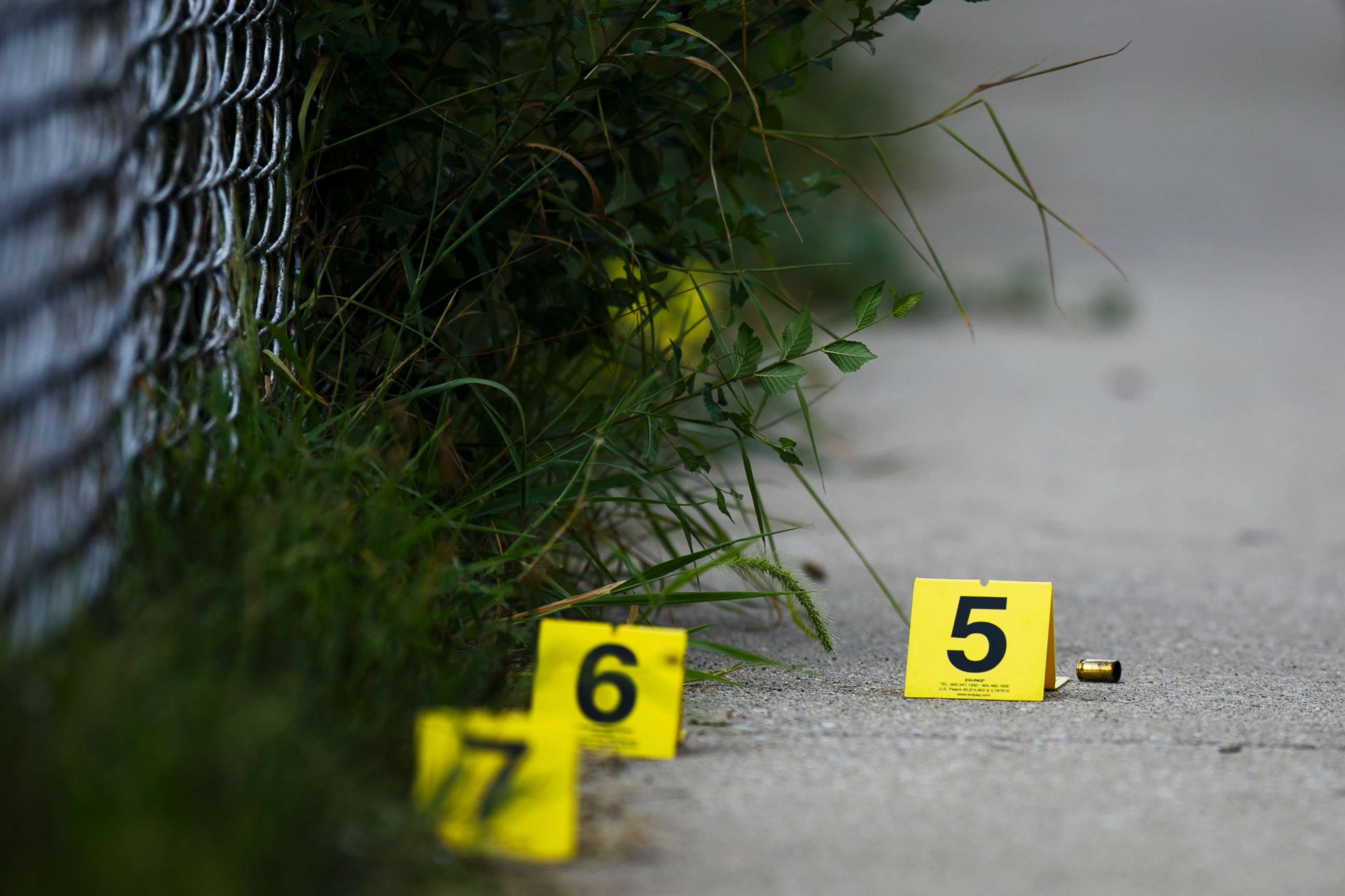 PHOTO: Evidence markers sit on the ground at the scene where a boy was killed after being shot in the abdomen while riding his bike in Chicago, Ill, Aug.5, 2018.