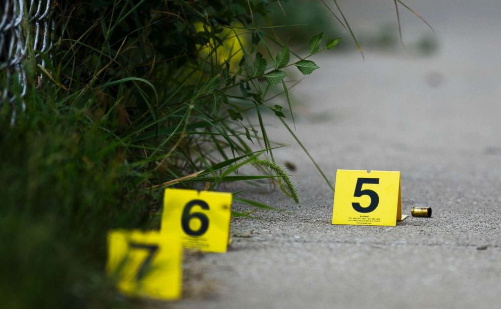 PHOTO: Evidence markers sit on the ground at the scene where a boy was killed after being shot in the abdomen while riding his bike in Chicago, Ill, Aug.5, 2018.