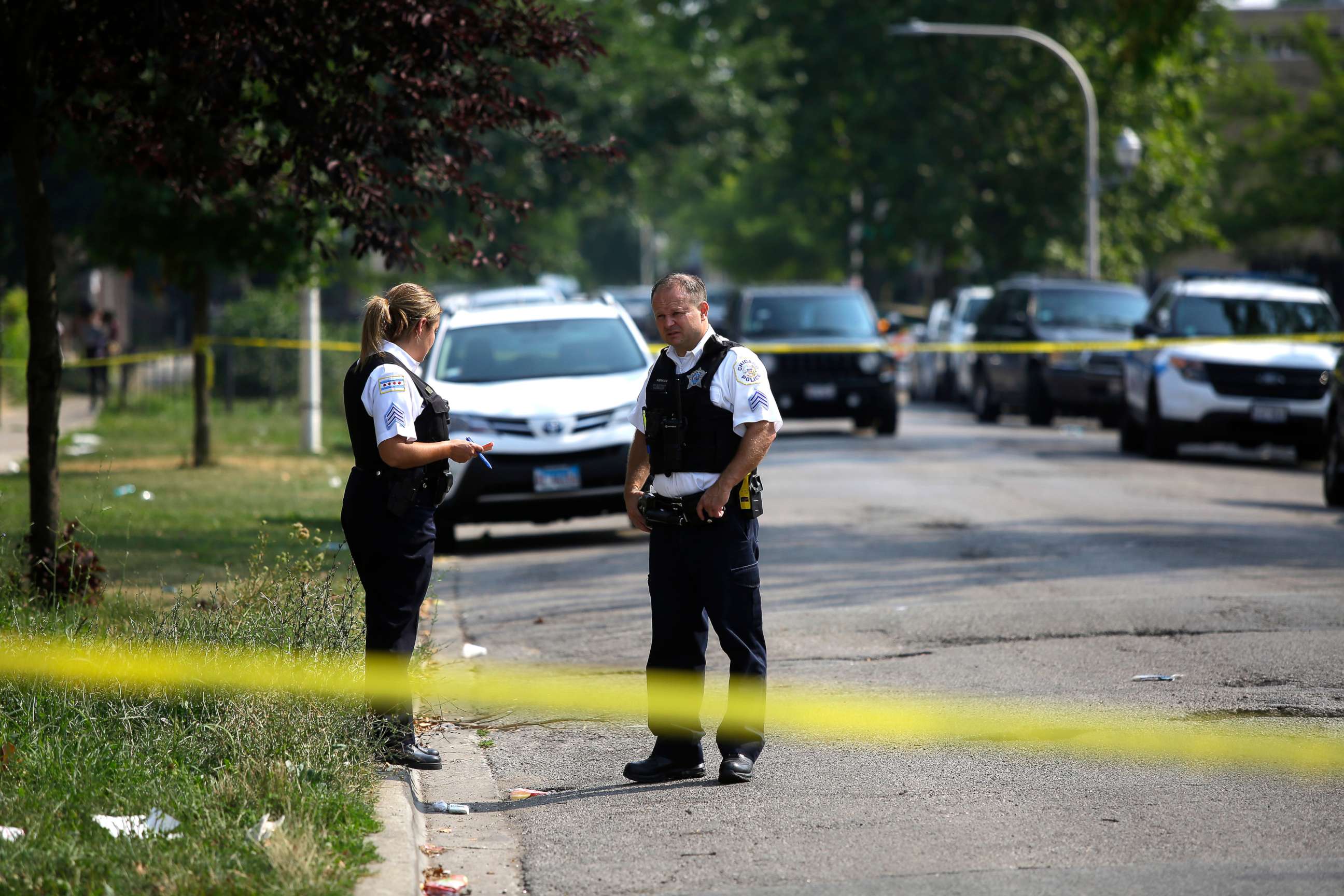 PHOTO: Chicago Police officers investigate a crime scene where a man was shot in the arm, August 12, 2018. According to statistics Chicago has more victims shootings and stabbings than both New York City and Los Angeles together.