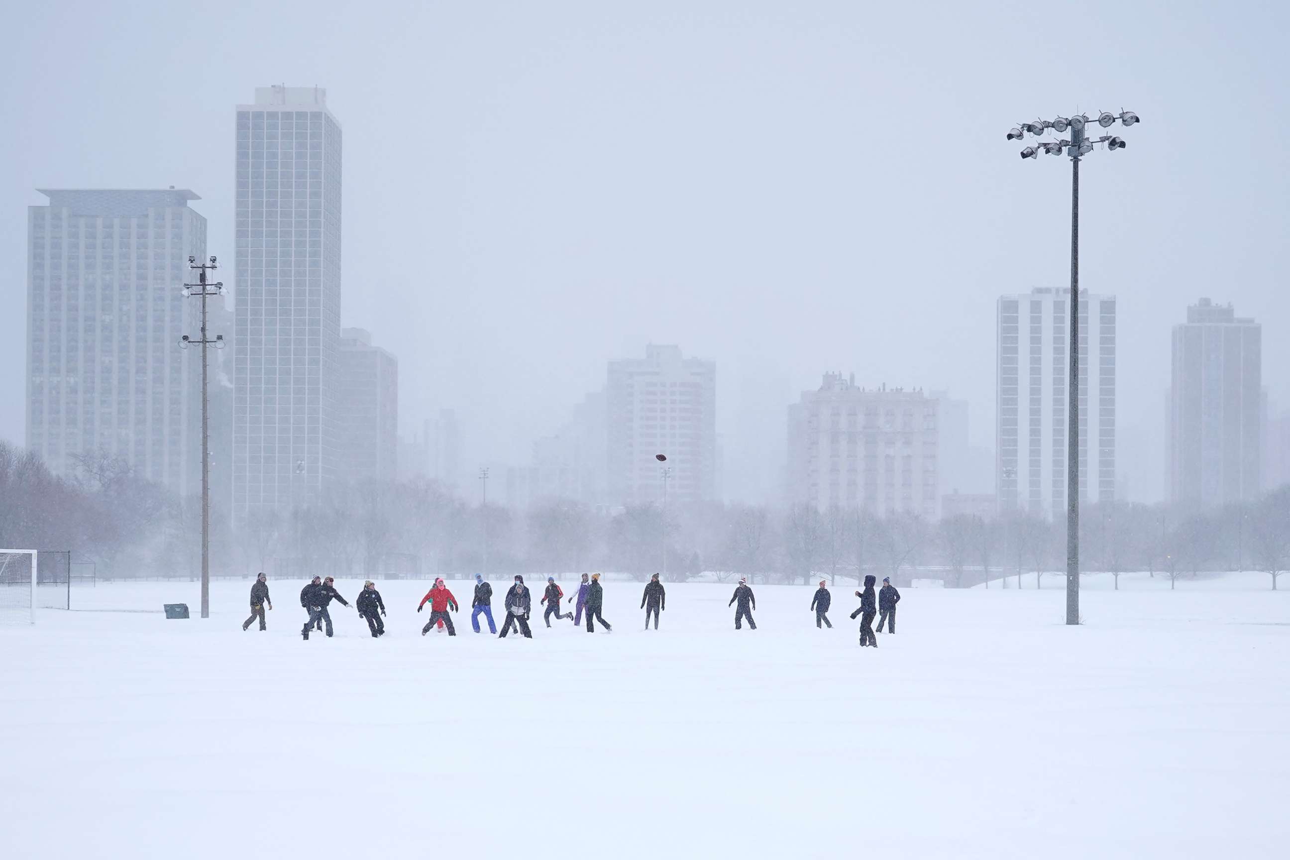PHOTO: Men play football on a soccer field in Chicago's Lincoln Park, Feb. 2, 2022.