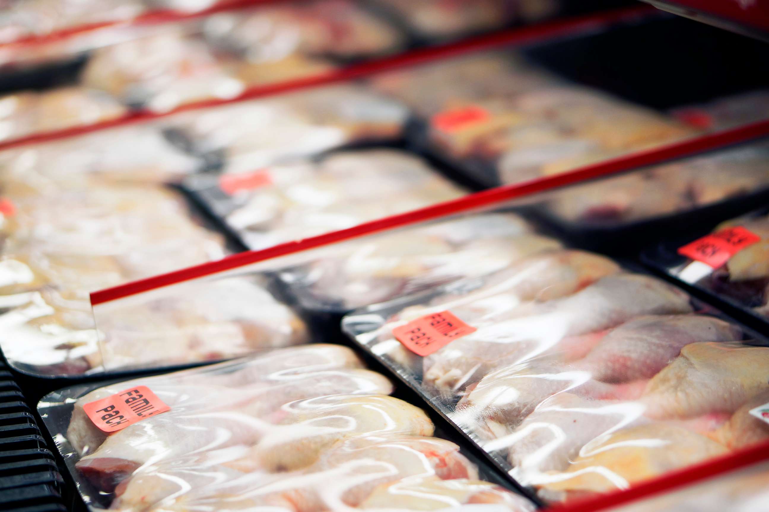 PHOTO: Packaged chicken legs in store refrigerator.