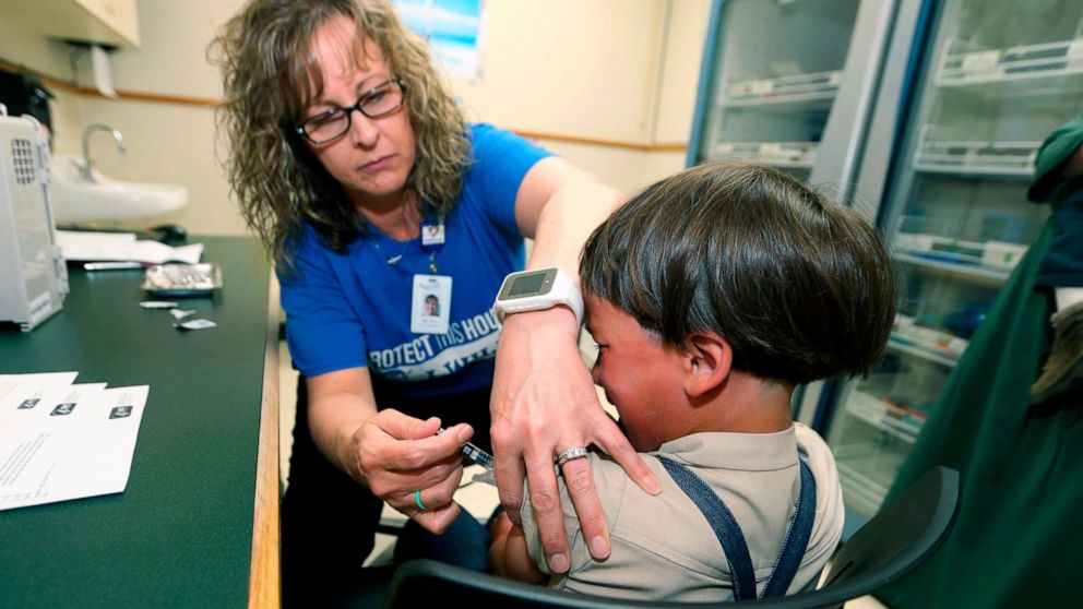PHOTO: A registered nurse and immunization outreach coordinator with the Knox County Health Department, administers a vaccination to Jonathan Detweiler, 6, at a facility in Mount Vernon, Ohio, May 17, 2019.