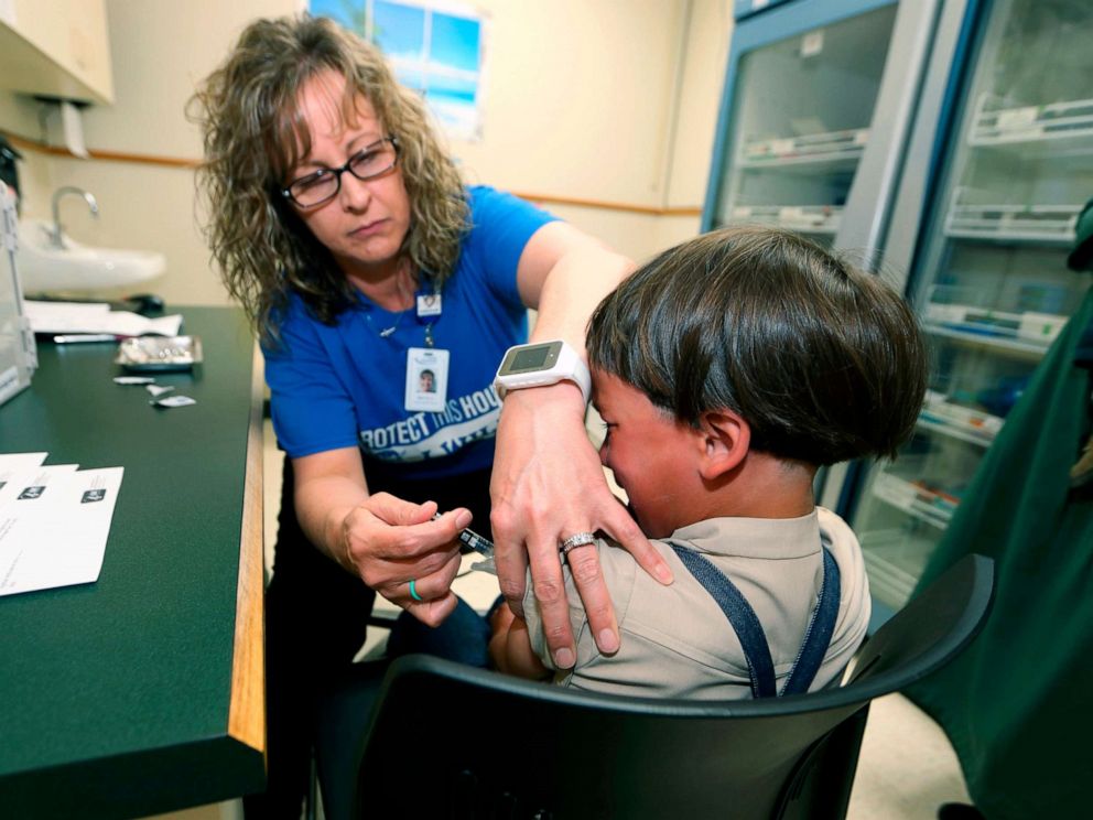 PHOTO: A registered nurse and immunization coordinator from the Knox County Department of Health administers a vaccine to Jonathan Detweiler, age 6, at a facility in Mount Vernon, Ohio on May 17, 2019.
