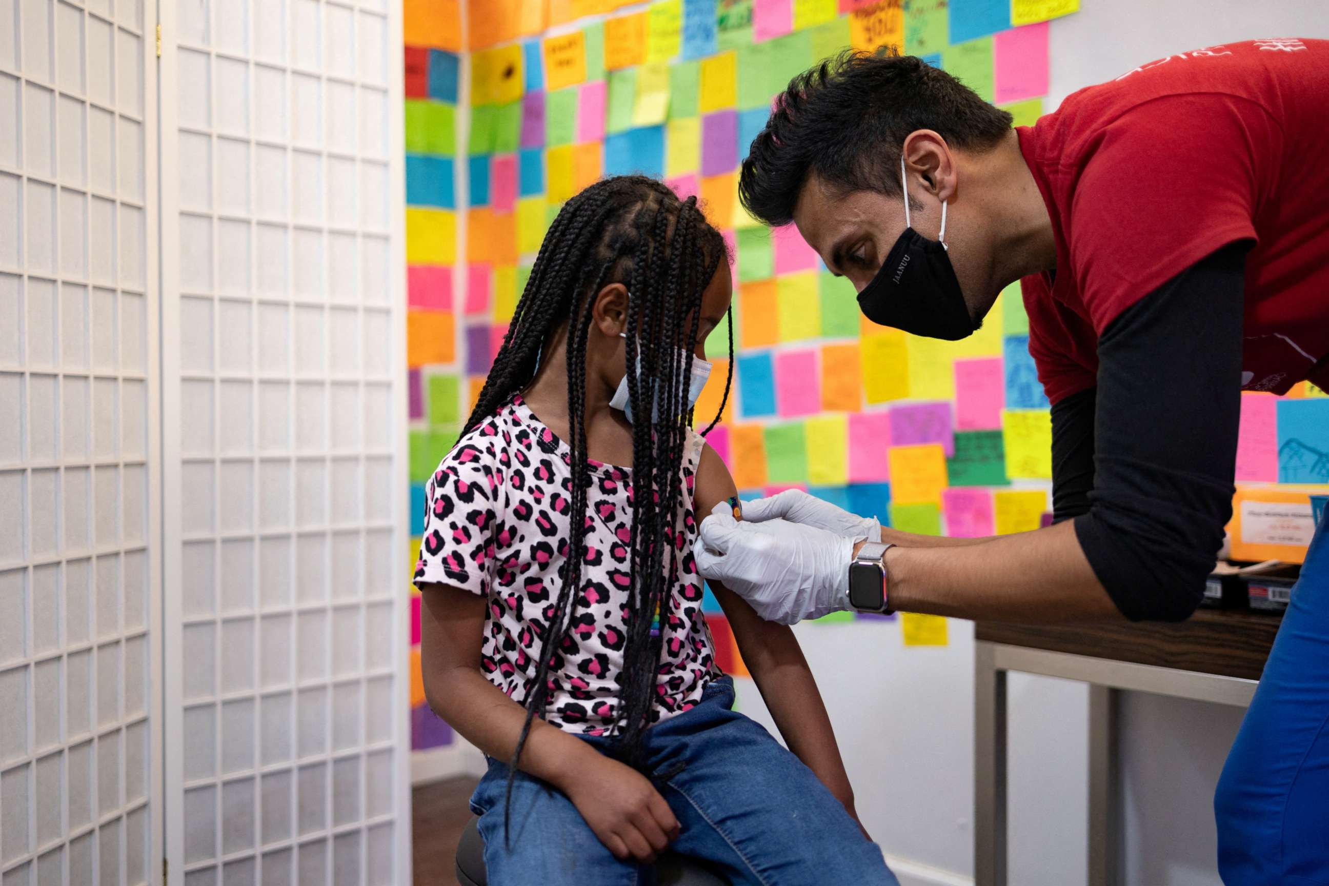PHOTO: Dr. Mayank Amin puts a band-aid on 5-year-old Lydia Jones after receiving a Pfizer-BioNTech COVID-19 booster vaccine at Skippack Pharmacy in Schwenksville, Penn., May 19, 2022.