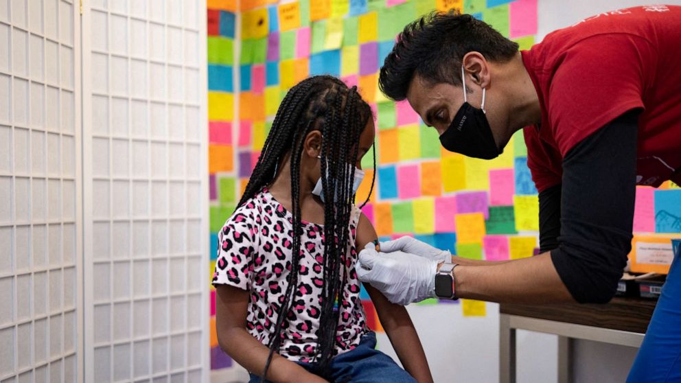PHOTO: Dr. Mayank Amin puts a band-aid on 5-year-old Lydia Jones after receiving a Pfizer-BioNTech COVID-19 booster vaccine at Skippack Pharmacy in Schwenksville, Penn., May 19, 2022.