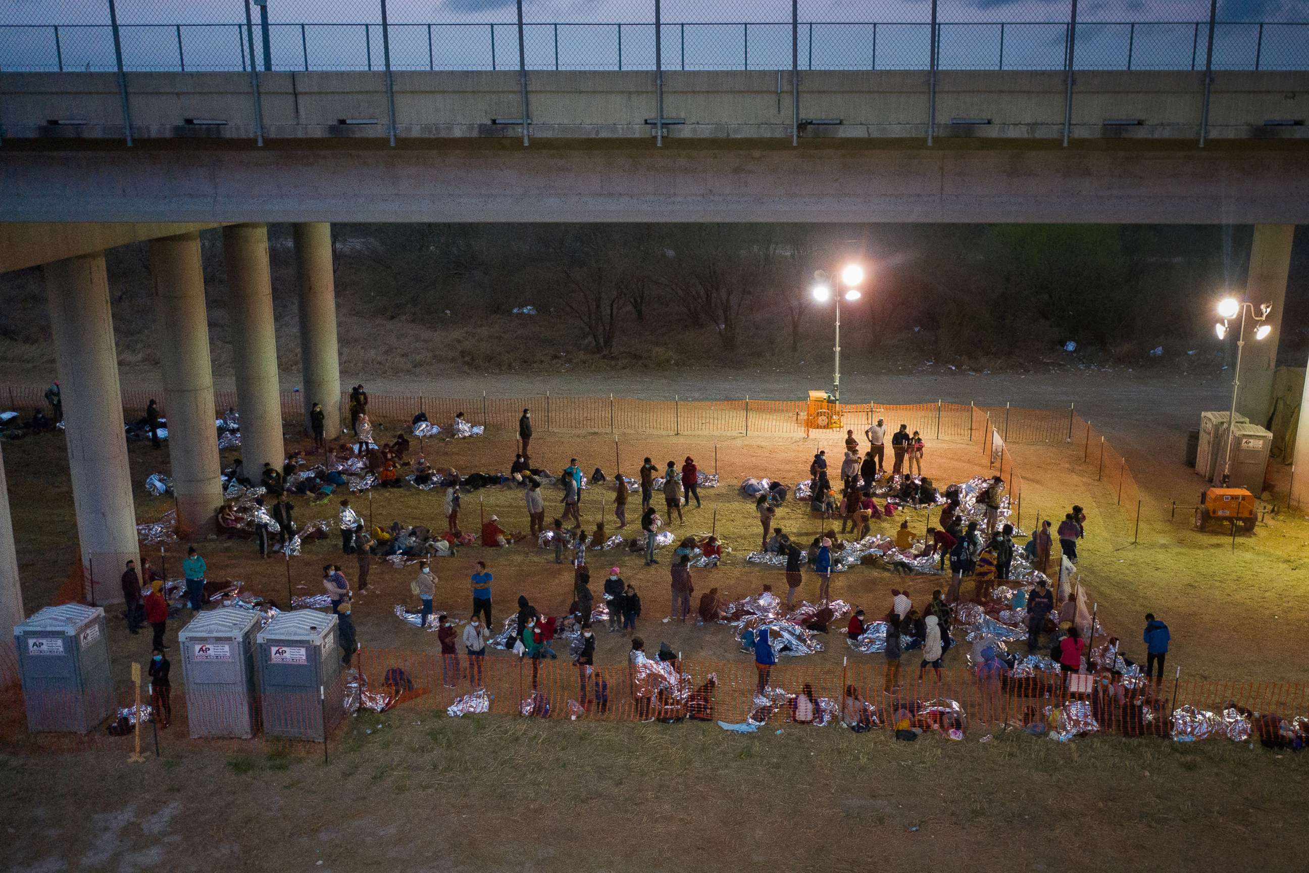 PHOTO: Asylum seeking migrant families and unaccompanied minors from Central America take refuge in a makeshift U.S. Customs and Border Protection processing center under the Anzalduas International Bridge in Granjeno, Texas, March 12, 2021. 