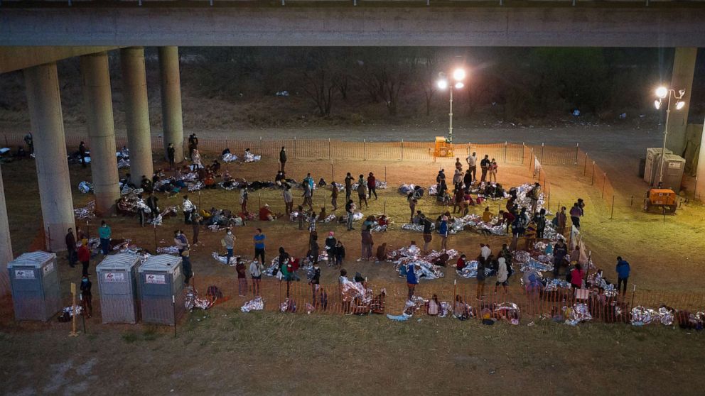 PHOTO: Asylum seeking migrant families and unaccompanied minors from Central America take refuge in a makeshift U.S. Customs and Border Protection processing center under the Anzalduas International Bridge in Granjeno, Texas, March 12, 2021. 