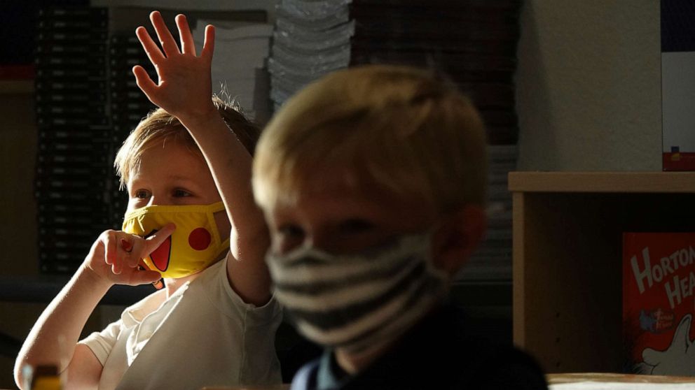 PHOTO: First Graders Alex Albin, left, and Tyler Custodio wear masks at the Addison Mizner School in Boca Raton, Fla., Aug. 10, 2021. Palm Beach County Schools opened the school year with a masking requirement with an opt-out option.