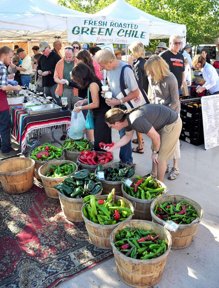 PHOTO: Shoppers select red and green chile peppers for sale at the popular vegetable market in Santa Fe, N.M., Aug. 21, 2013. 