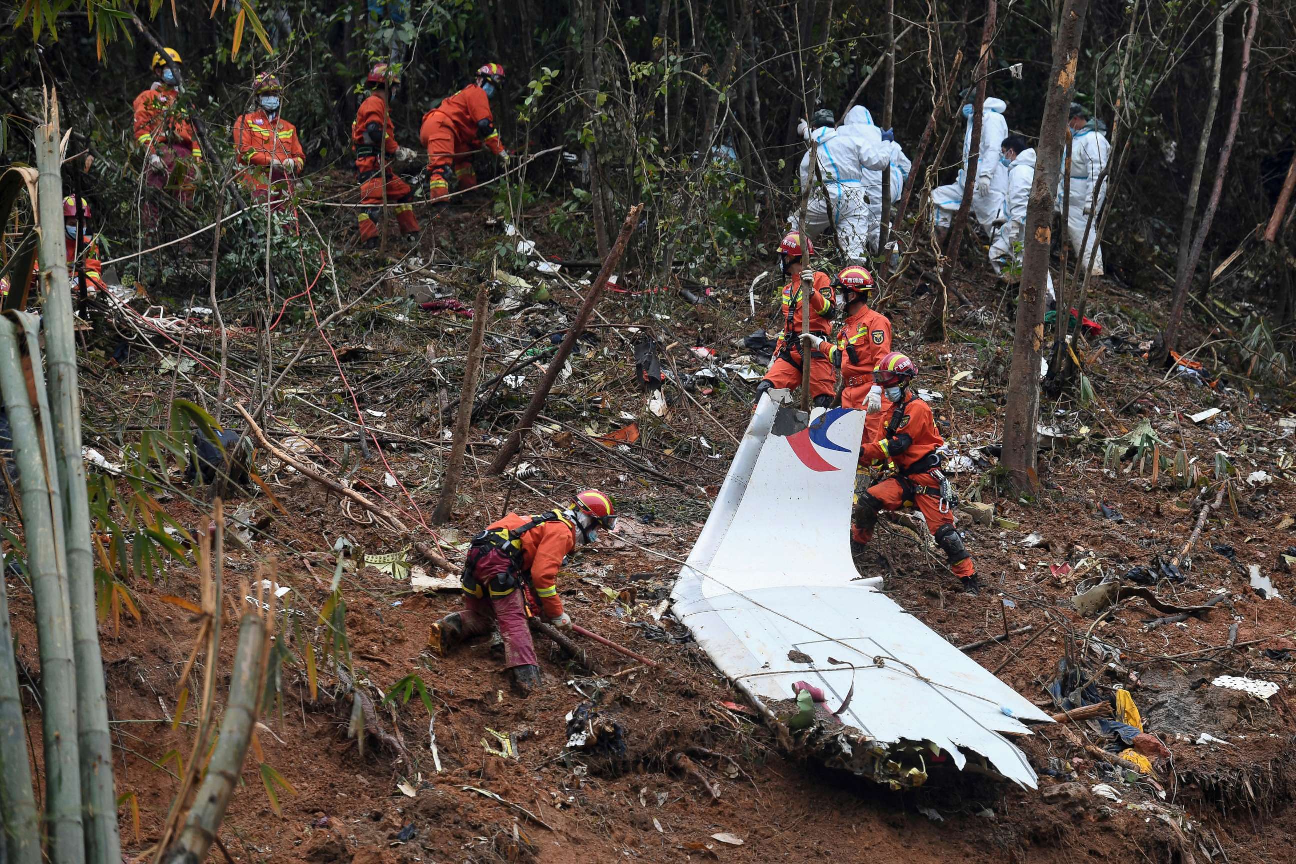 PHOTO: In this photo released by Xinhua News Agency, workers search through debris at the China Eastern flight crash site in Tengxian County in southern China's Guangxi Zhuang Autonomous Region, March 24, 2022.