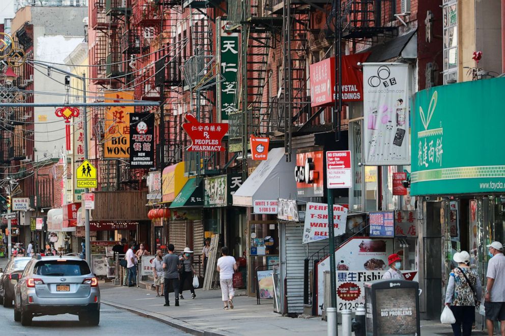 PHOTO: People walk in a street in Chinatown, New York, on June 24, 2020.