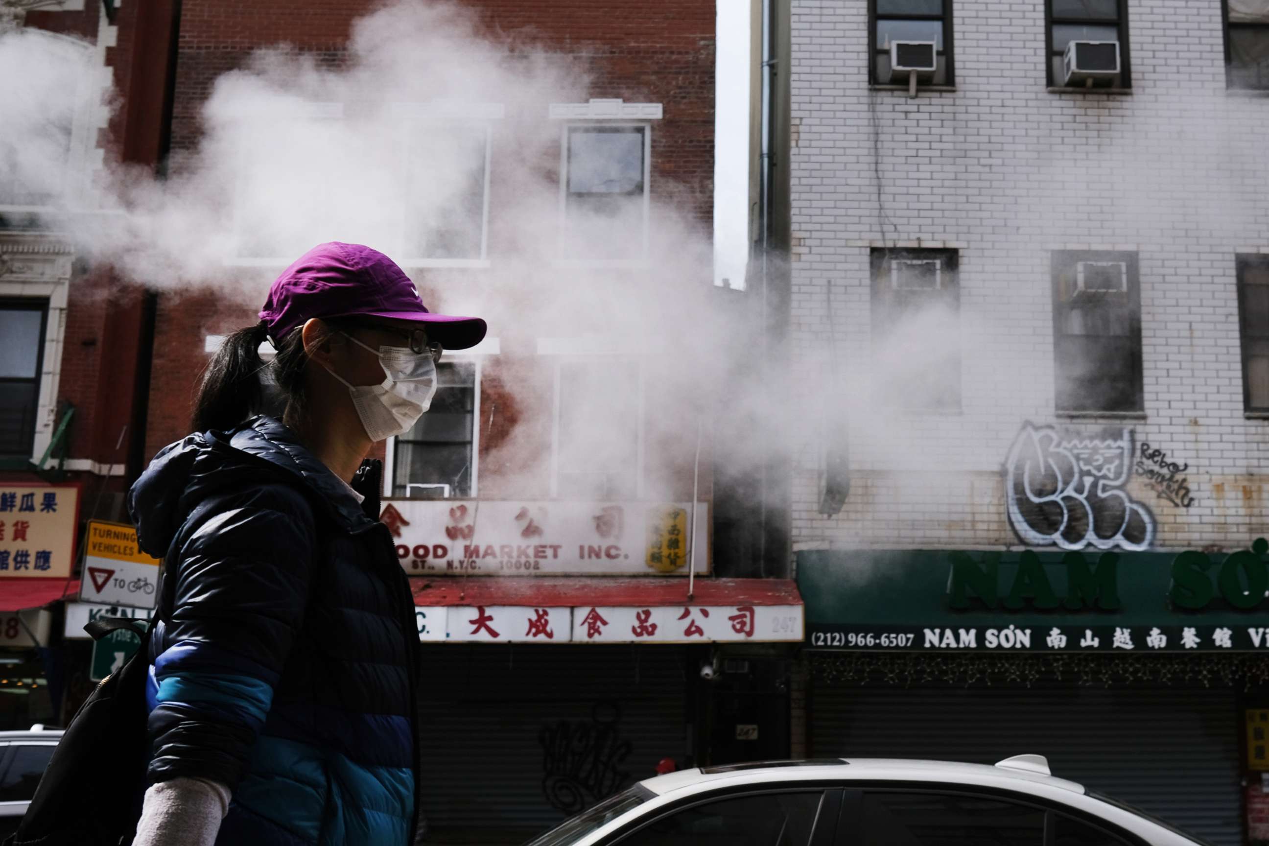 PHOTO: People walk down a street in Chinatown  as the coronavirus keeps financial markets and businesses mostly closed, April 21, 2020, in New York.