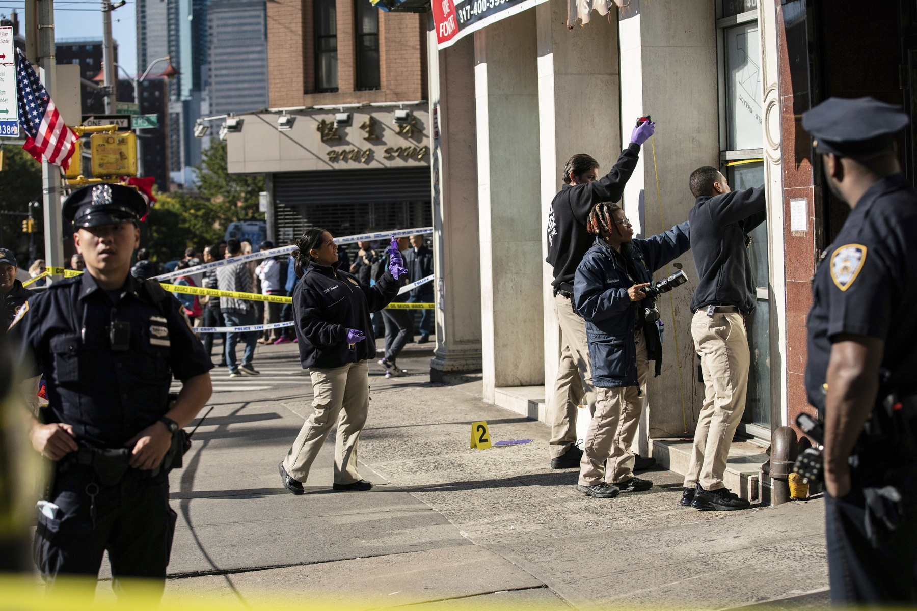 PHOTO: New York Police Department officers investigate the scene of an attack in Manhattan's Chinatown neighborhood, Oct. 5, 2019, in New York.