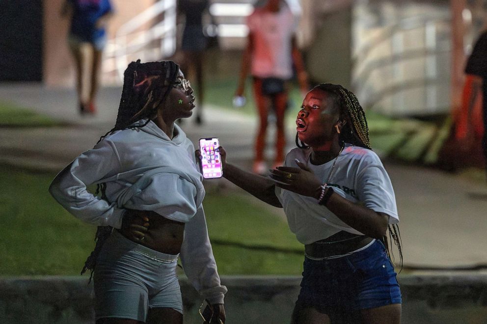 PHOTO: People are in shock after hearing multiple gun shots during a high school football game between Del City and Choctaw in Choctaw, Okla., on Aug. 25, 2023.