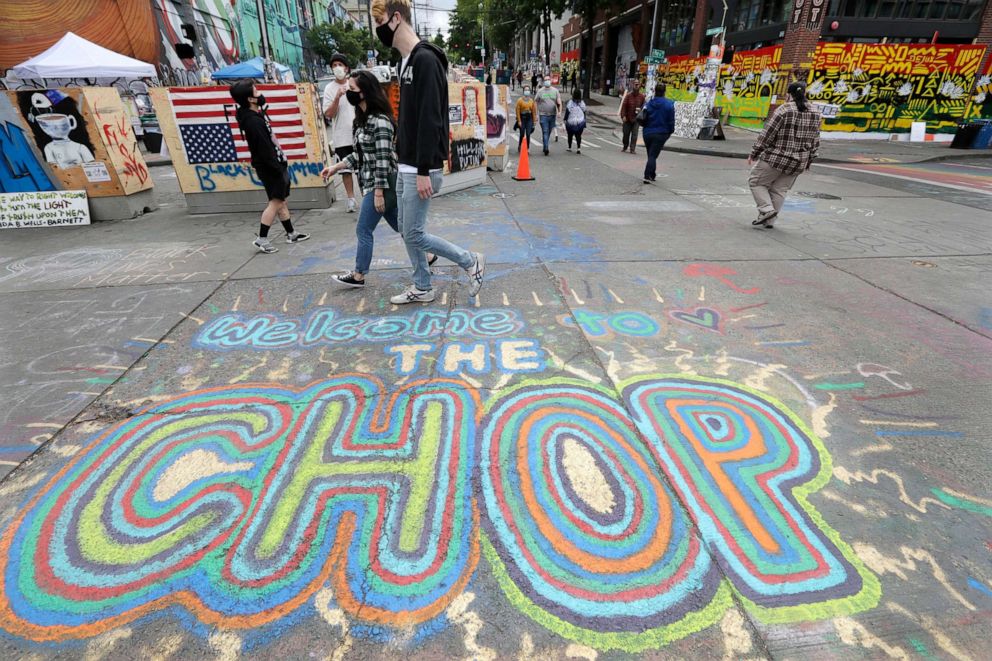 PHOTO: Pedestrians walk on June 21, 2020, in the Capitol Hill neighborhood of Seattle, Washington, where streets are blocked off in what has been named the Capitol Hill Occupied Protest zone, or CHOP.