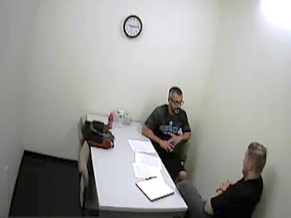 PHOTO: Chris Watts speaks with investigators after being arrested for the murder of his wife and two children in police surveillance released, Nov. 29, 2018.