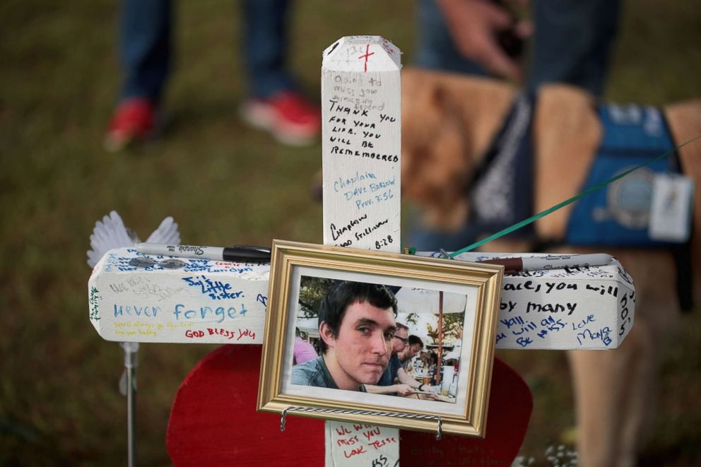 PHOTO: A photo of Christian Garcia hangs on a cross at a memorial in front of Santa Fe High School, May 22, 2018 in Santa Fe, Texas.