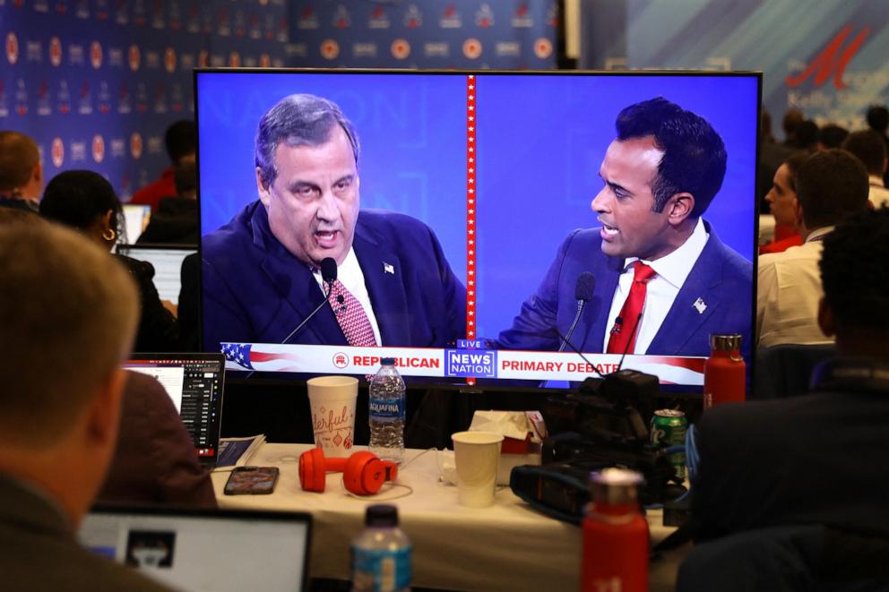 PHOTO: Journalists in the press room watch as Republican presidential candidate and former NJ Governor Chris Christie and fellow candidate Vivek Ramaswamy discuss an issue during the fourth Republican candidates' debate in Tuscaloosa, Ala., Dec. 6, 2023. 