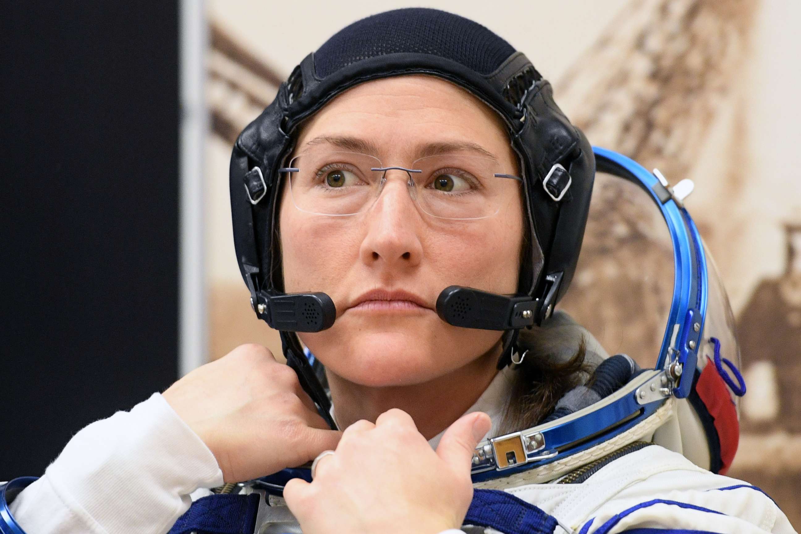 PHOTO: NASA astronaut Christina Hammock Koch, a member of the International Space Station expedition 59/60, looks on as her spacesuit is tested prior to launch from the Russian-leased Baikonur cosmodrome in Kazakhstan, March 14, 2019.