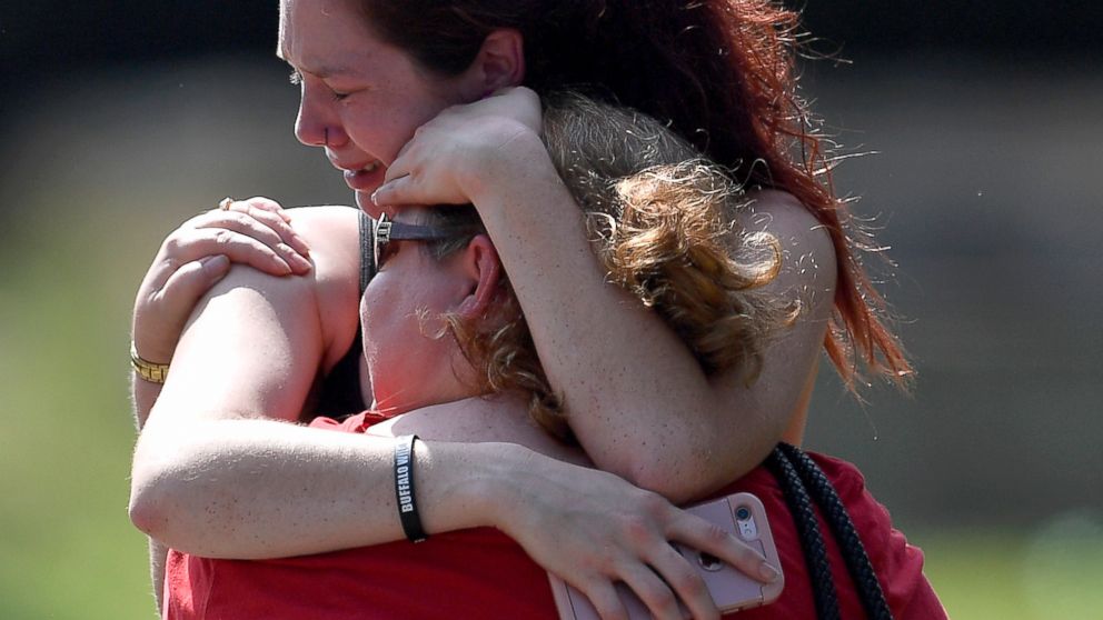 PHOTO: Kaitlyn Adams, a member of the Burnette Chapel Church of Christ, hugs another church member at the scene after a deadly shooting at the church, Sept. 24, 2017, in Antioch, Tenn.