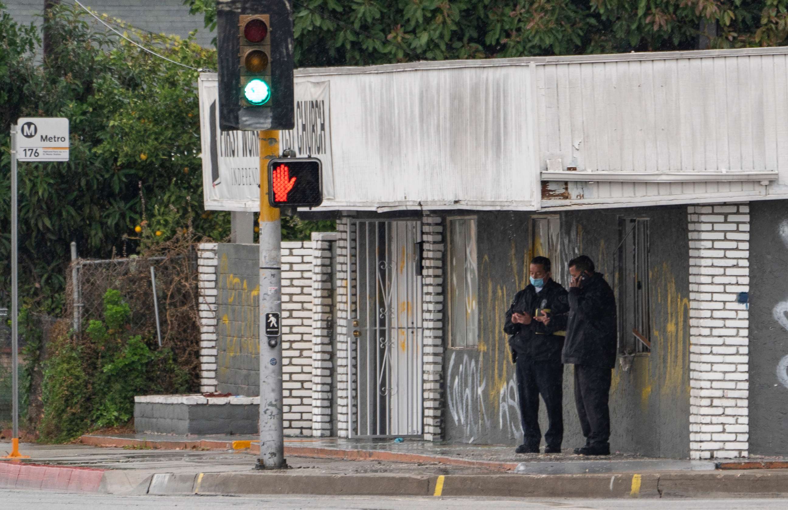 PHOTO: El Monte Police Chief David Reynoso, left, with another officer stand outside the First Works Baptist Church tagged with graffiti, after an explosion in El Monte, Calif., Saturday, Jan. 23, 2021.