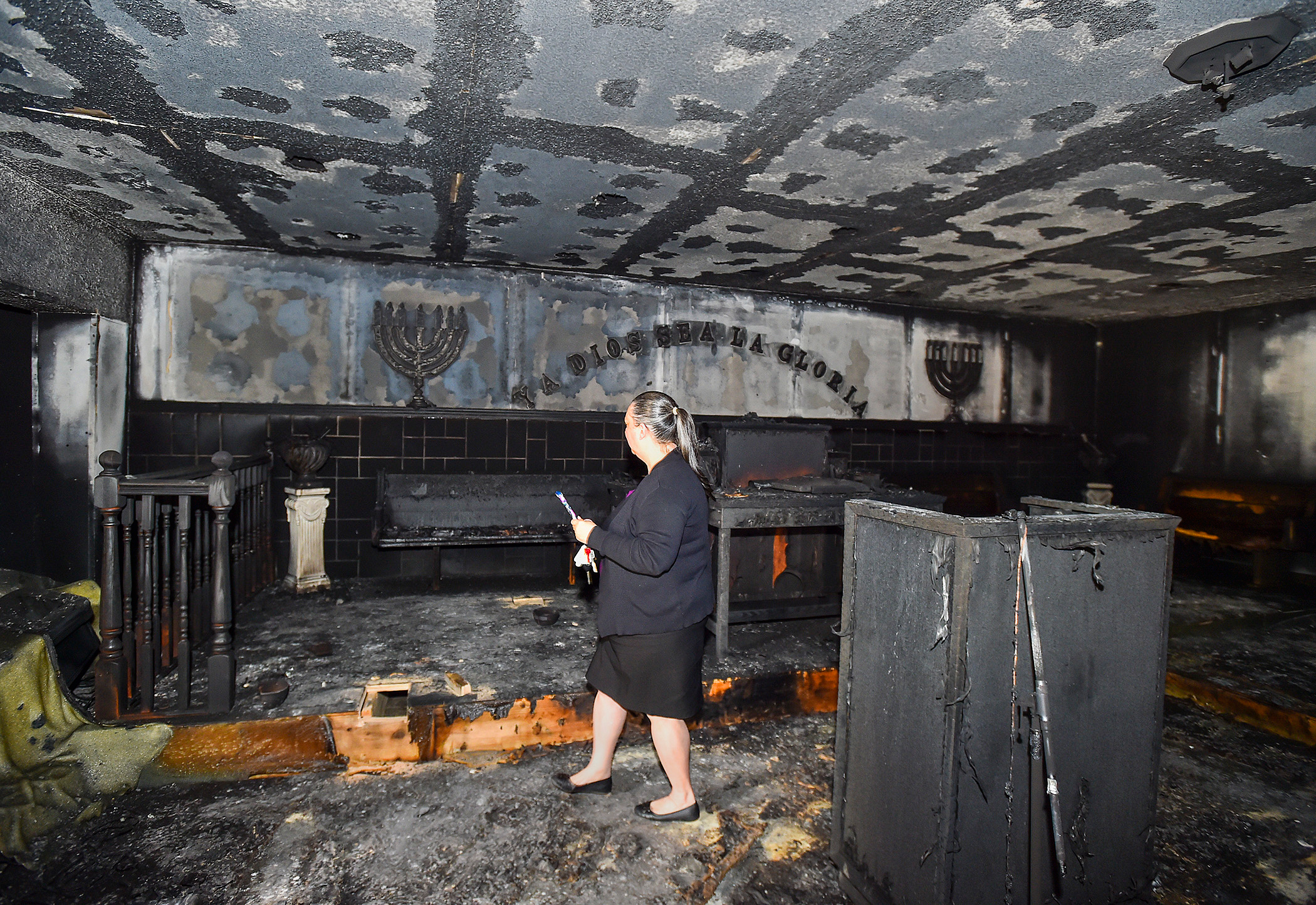 PHOTO: Elizabeth Collazo, the daughter of Pastor Carmen L. Cruz, walks through the badly damaged church following the fire at Iglesia Pentecostal De Bethlehem Church, April 23, 2019, in Allentown, Pa.