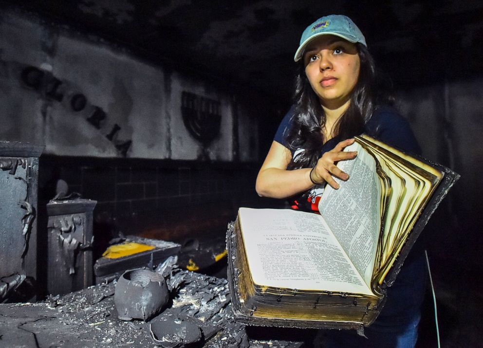 PHOTO: Tasha Collazo, a granddaughter of Pastor Carmen L. Cruz, shows a bible that survived the fire at Iglesia Pentecostal De Bethlehem Church on April 23, 2019 in Allentown, Pa.