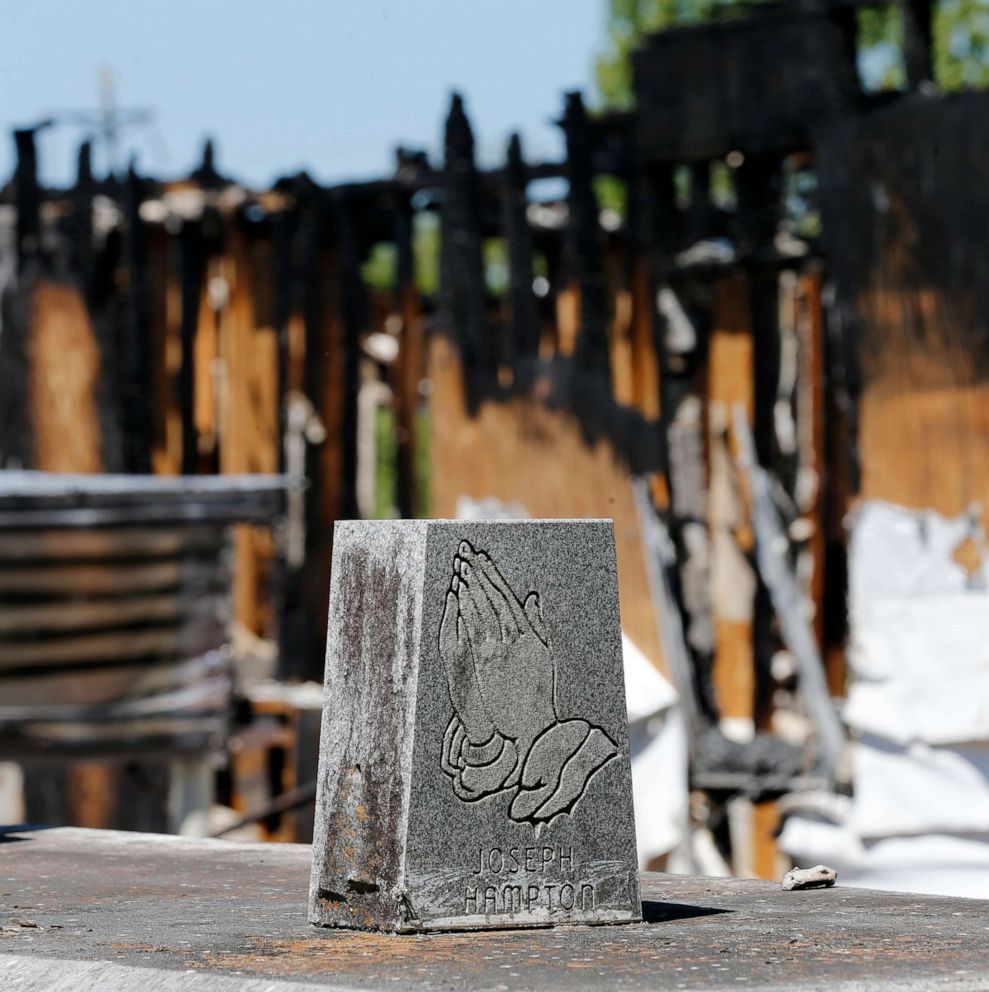 PHOTO: Graves from a cemetery are seen behind the burnt ruins of the Greater Union Baptist Church, one of three that recently burned down in St. Landry Parish, are seen in Opelousas, La., April 10, 2019.