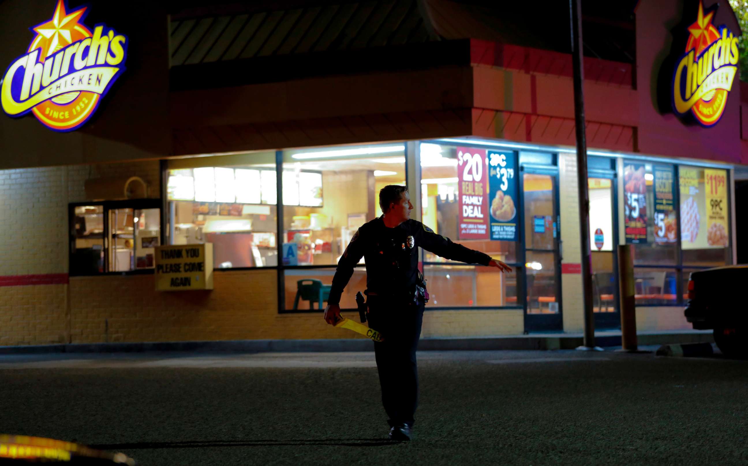 PHOTO: San Diego Police officers seal off the area around a Church's Chicken eatery in San Diego after a shooting on Nov. 6, 2019.