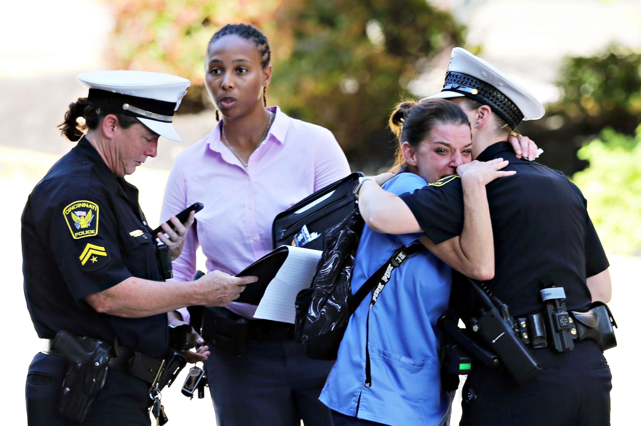 PHOTO: A police officer comforts a woman outside UCMC ER following an active shooter situation in downtown Cincinnati, Sept. 6, 2018. 