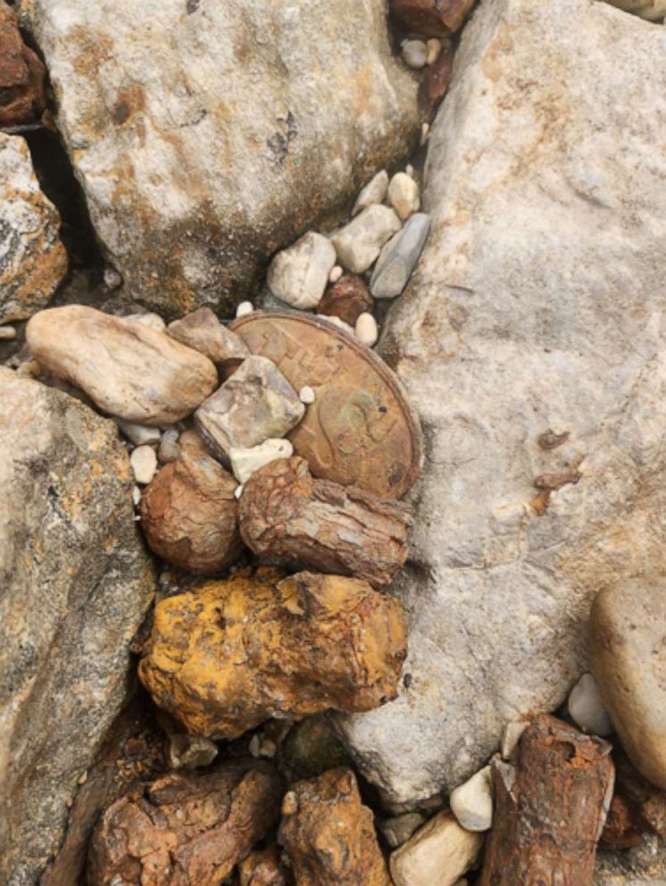 PHOTO: A Civil War union US cartridge box plate laying among the rocks of the Mississippi river below the I55 bridge. 