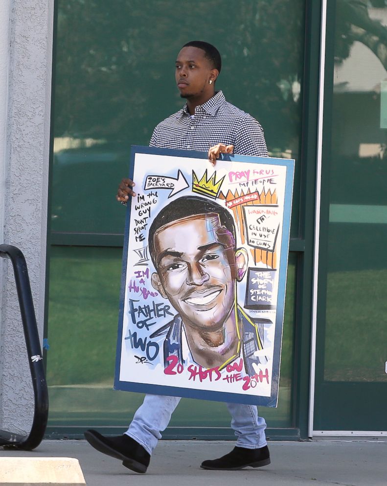PHOTO: An attendee for the wake of police shooting victim Stephon Clark carries a drawing of Clark to the Bayside of South Sacramento Church, March 28, 2018, in Sacramento, Calif.  