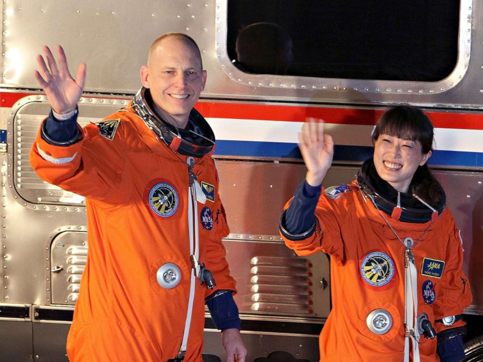 FILE PHOTO: NASA astronaut Clayton Anderson, left, and NASA's STS-131 Japan Aerospace Exploration Agency astronaut Naoko Yamazaki wave as they walk out of the operations and checkout building at Kennedy Space Center April 5, 2010 in Cape Canaveral, Fla.