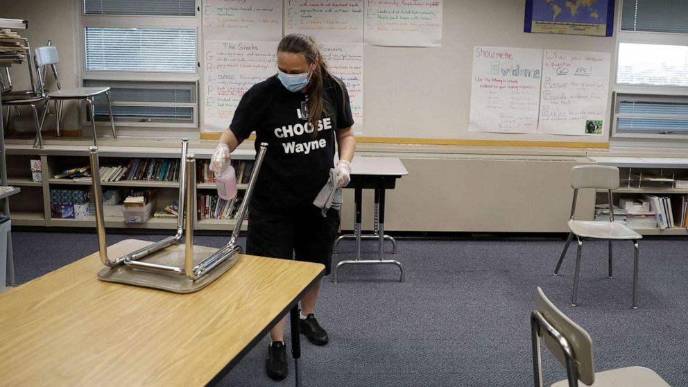 PHOTO: Diane Tomey cleans a classroom at McClelland Elementary School, June 22, 2020, in Indianapolis.