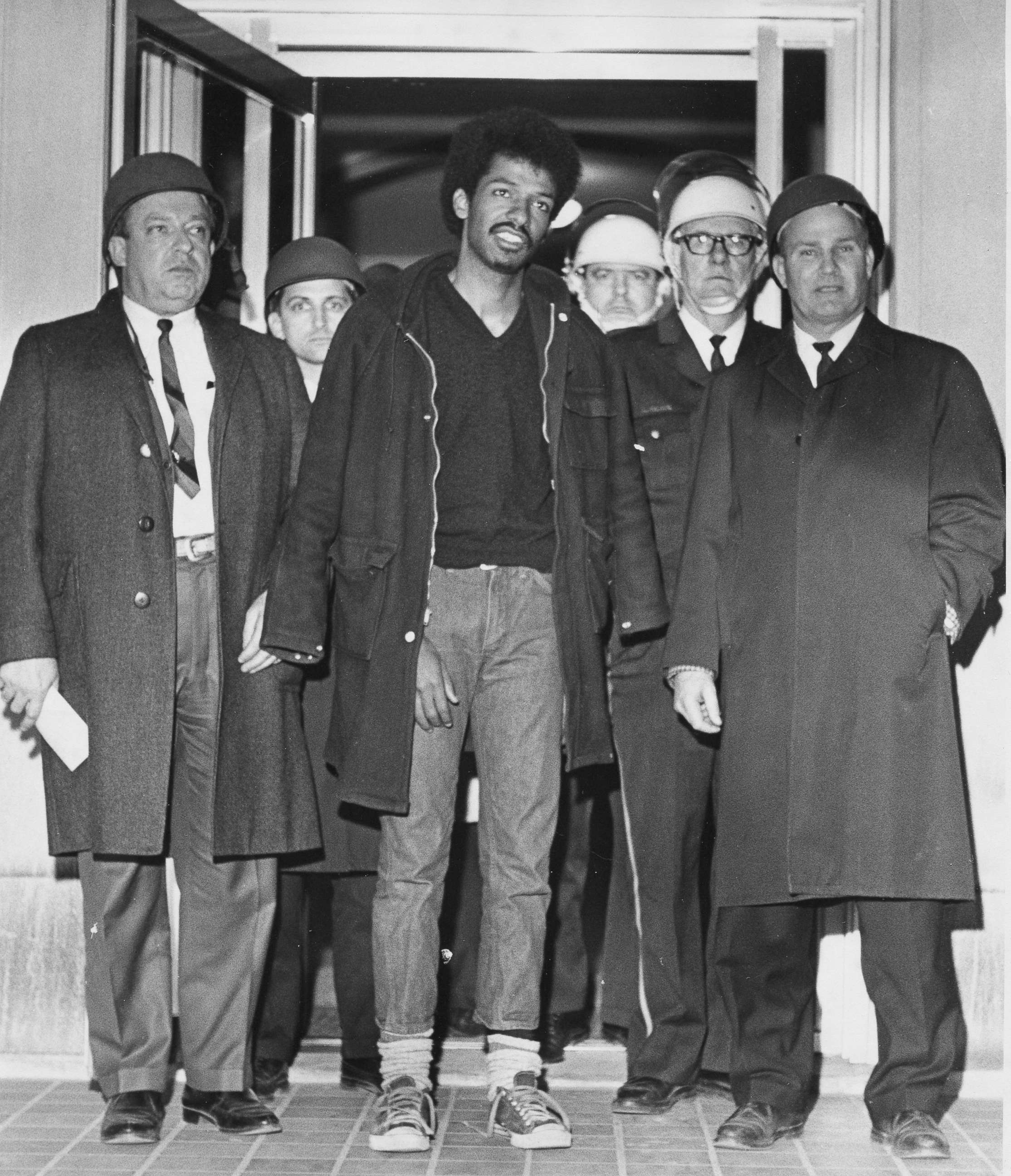 PHOTO: Cleveland Sellers, center, stands with officers after his arrest the previous night in Orangeburg, S.C., where three people were killed and others wounded, Feb. 9, 1968.