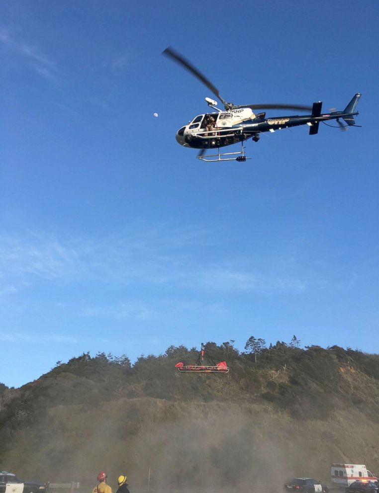 PHOTO: A helicopter hovers over the scene where a vehicle plunged off a cliff in Northern California near Mendocino, Calif., March 27, 2018.