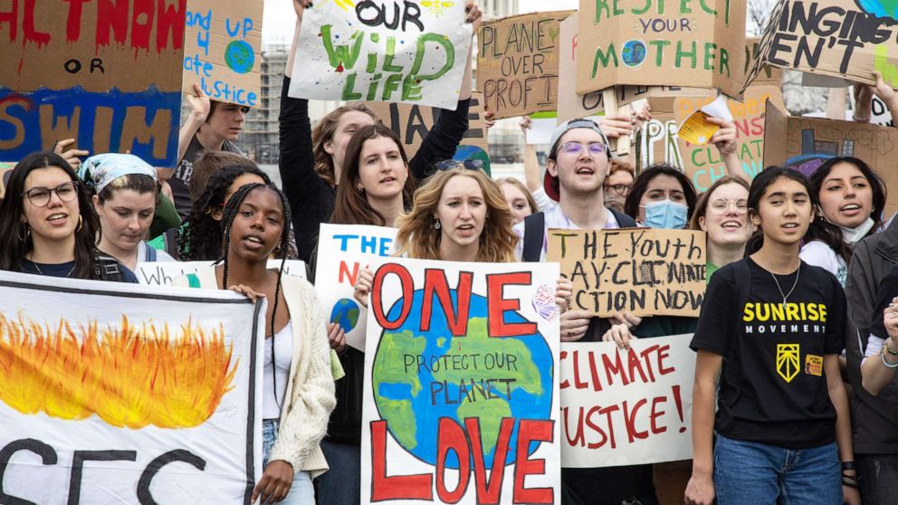 PHOTO: In this March 25, 2022, file photo, climate activists pose for a photo after a march from the White House to the U.S. Capitol in Washington, D.C.