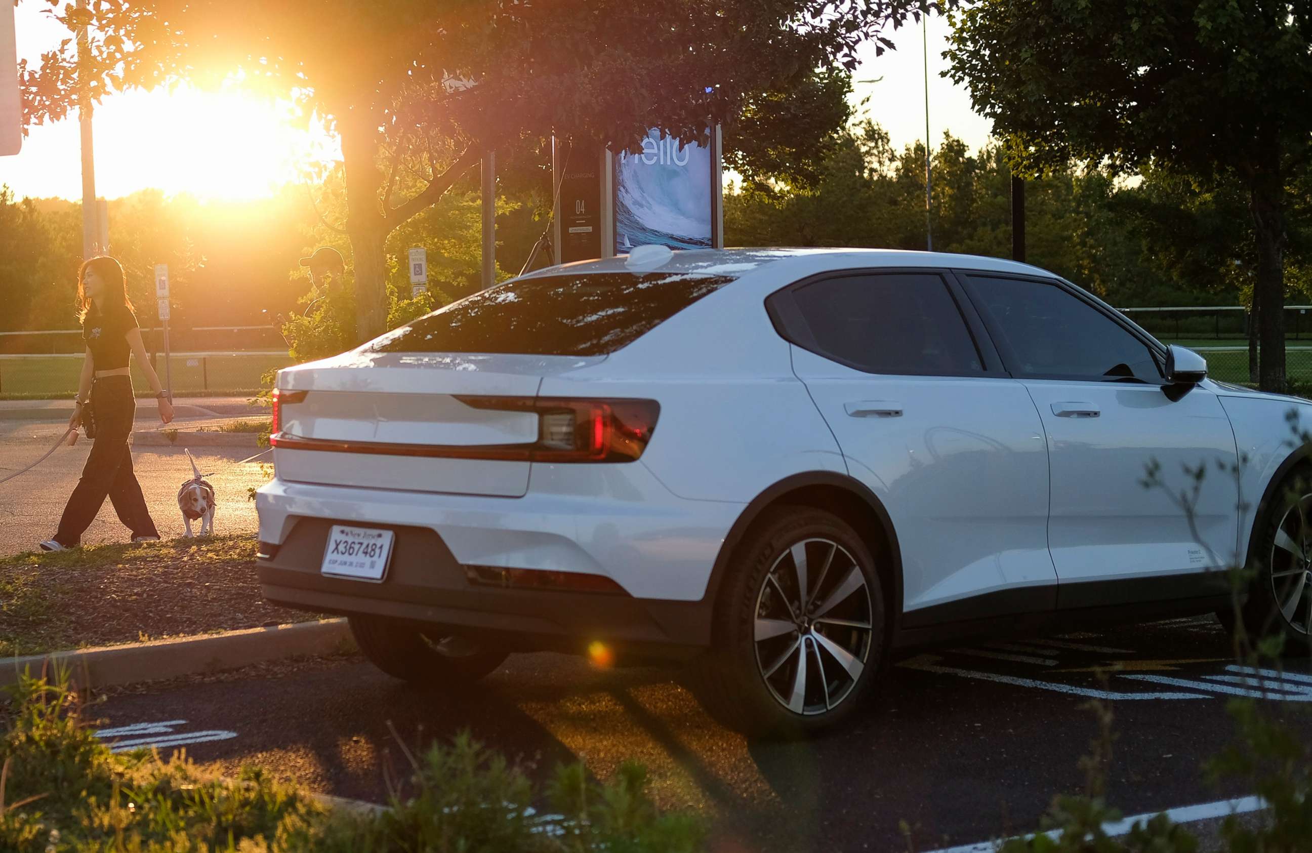 PHOTO: The sun sets behind  EV charging stations in Leonia, N.J.,June 17, 2022.