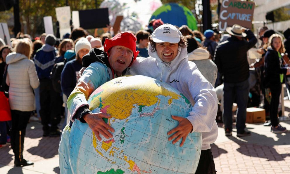 PHOTO: Activists are seen hugging an inflatable globe before hearing from Swedish teen environmental activist Greta Thunberg leads at a climate change rally in Charlotte, NC., Nov. 8, 2019.