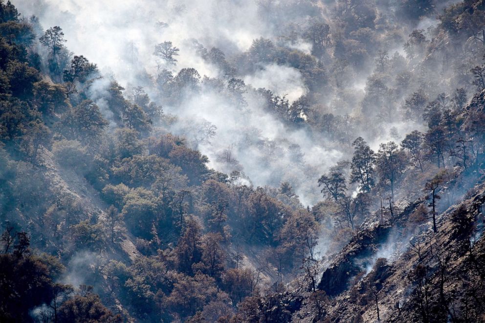 PHOTO: The fire is still burning in the hills and mountain above the scorched areas burnt by the Sheep Fire near Wrightwood, Calif., June 13, 2022.