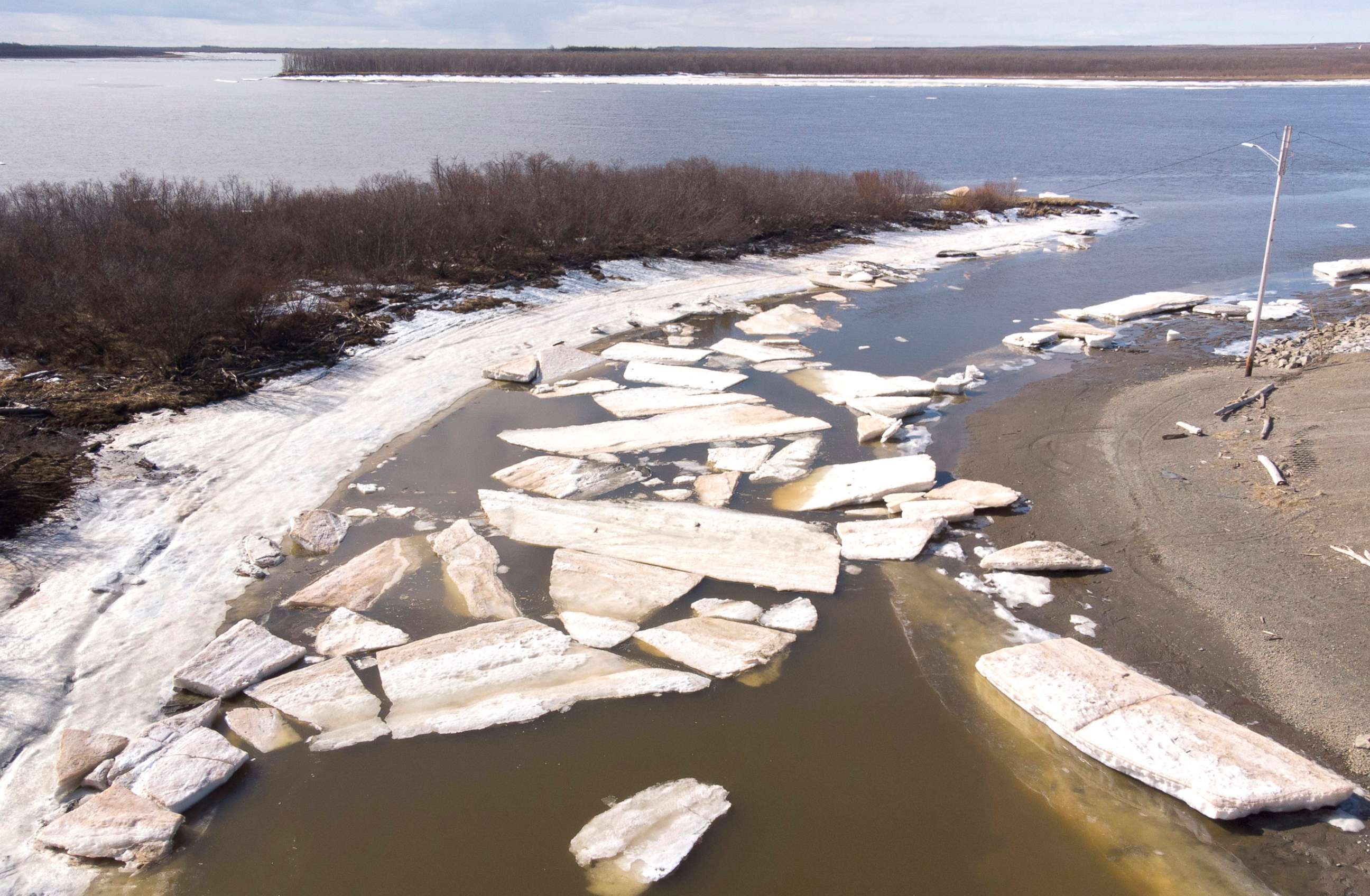 PHOTO: Melting ice beside severe erosion of the permafrost tundra at Bethel on the Yukon Delta in Alaska, April 15, 2019. Alaska has been warming twice as fast as the global average, with temperatures in February and March shattering records.