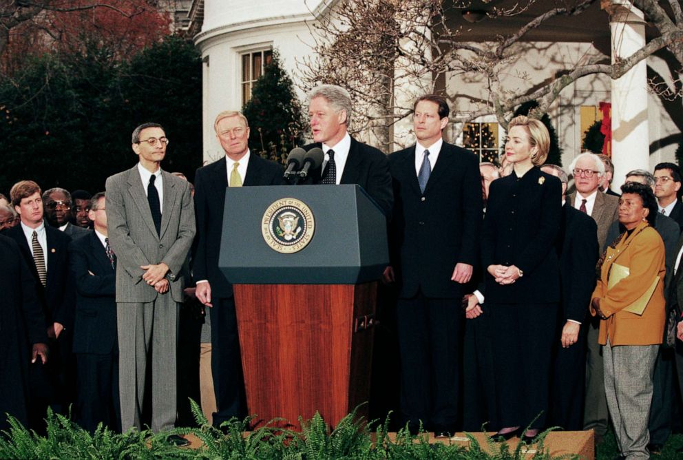 PHOTO: Surrounded by Congressional Democrats, President Bill Clinton reacts to being impeached by the House of Representatives outside of the oval office in the White House Rose Garden, Washington, DC, December 19, 1998.