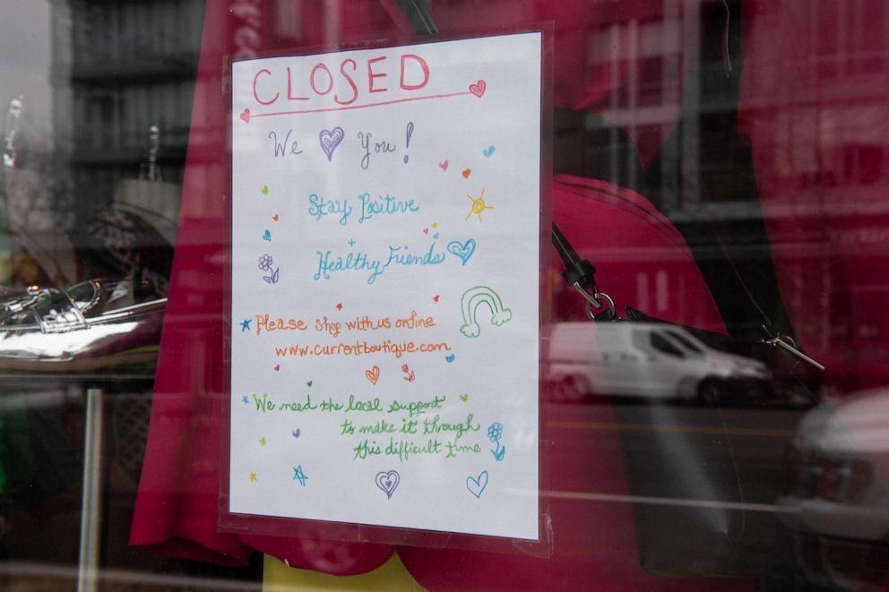 PHOTO: A sign is seen in the window of a clothing store closed due to the novel coronavirus outbreak in Washington, D.C., on March 18, 2020. 