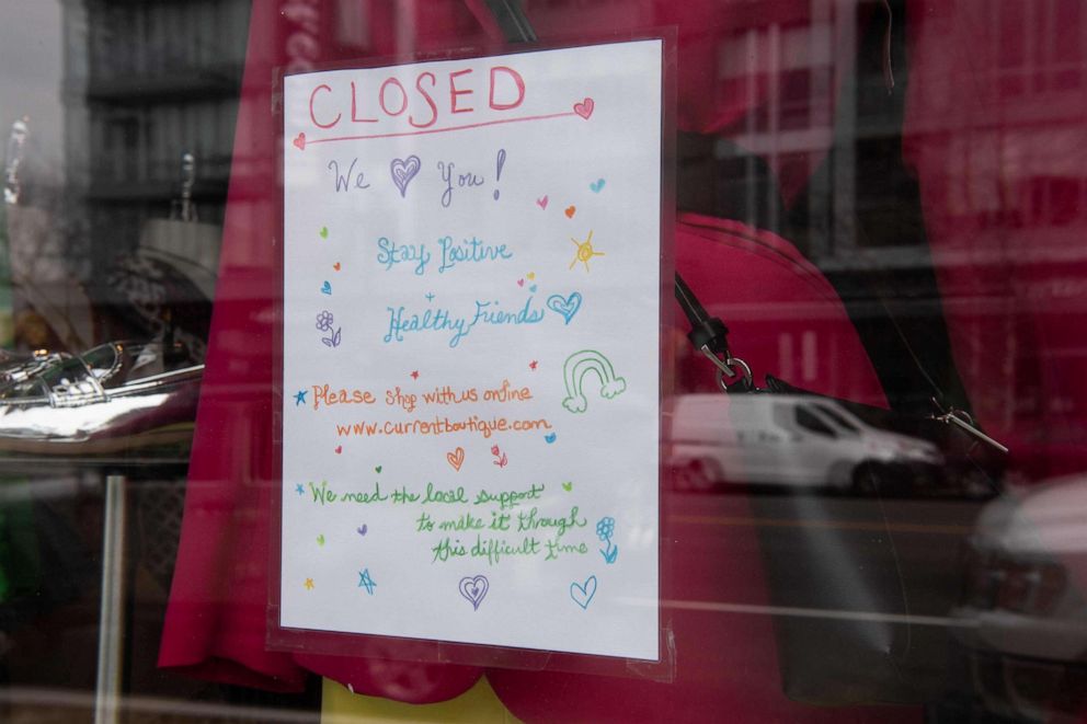 PHOTO: A sign is seen in the window of a clothing store closed due to the novel coronavirus outbreak in Washington, March 18, 2020. 